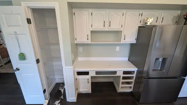 Old built-in kitchen desk with white cabinets before the pantry project
